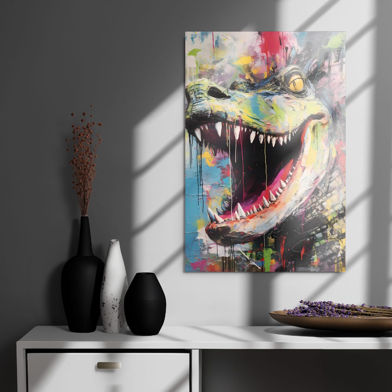 "Primal Roar" glossy metal poster 20"x30" on modern gray wall above console decor with window-light shadows, contemporary graffiti dinosaur portrait with huge open jaws, sharp teeth, yellow eye, pink mouth, and colorful street-art paint splashes, by GiveMeMood