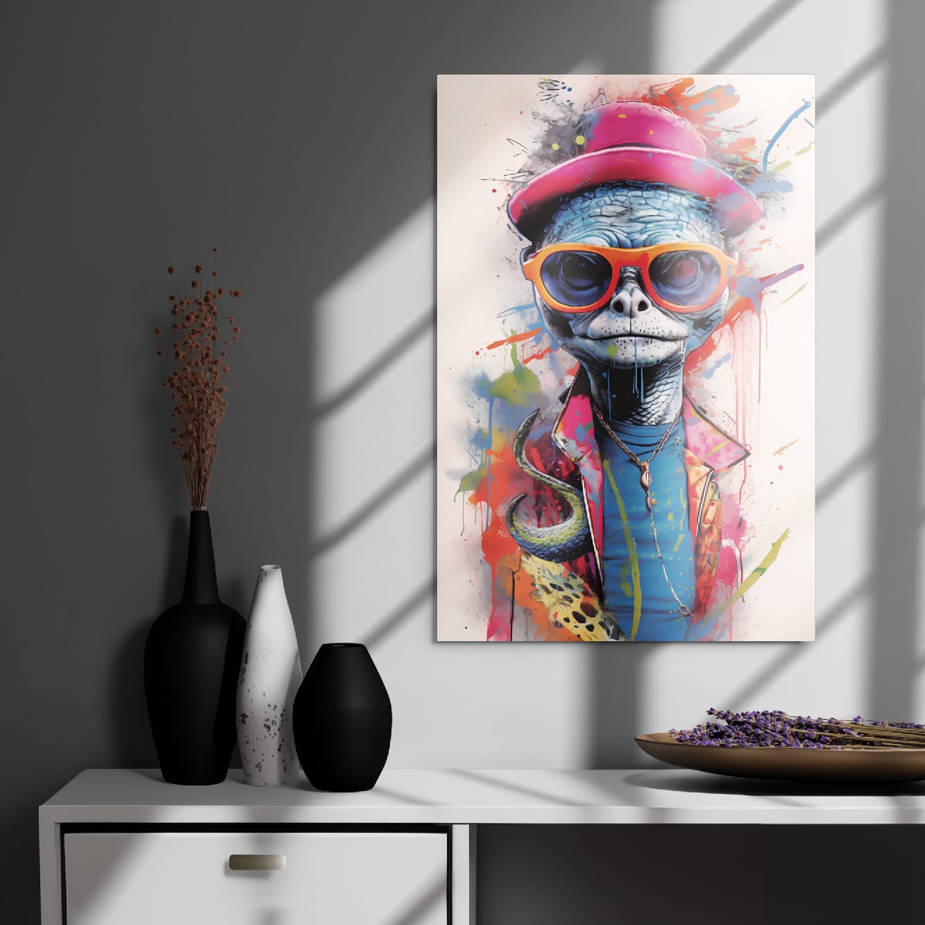 "Reptile Swagger" glossy metal poster 20"x30" on modern gray wall above console decor with window-light shadows, bold street-art turtle portrait featuring a pink hat, orange sunglasses, blue reptile skin texture, and colorful splatter accents, by GiveMeMood