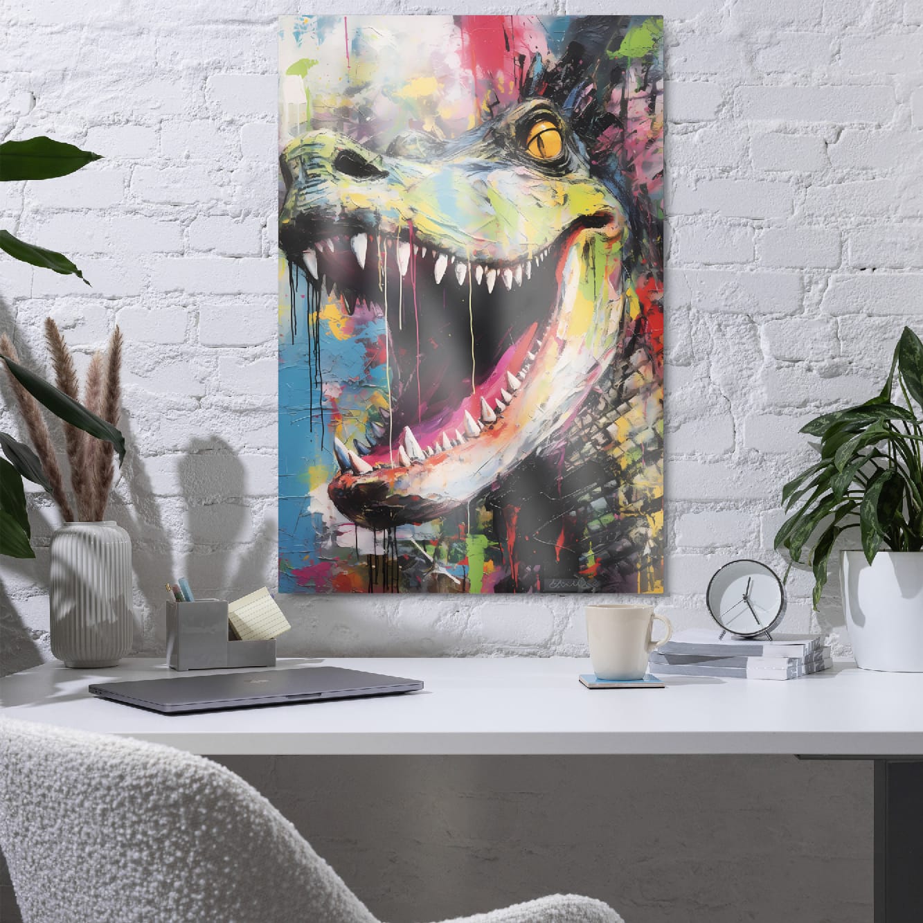 "Primal Roar" glossy metal poster 24"x36" in a home office above desk on white brick wall, abstract dinosaur wall art with wide open jaws, sharp white teeth, golden-yellow eye, teal-green snout, and hot-pink tongue in paint-drip graffiti style, by GiveMeMood