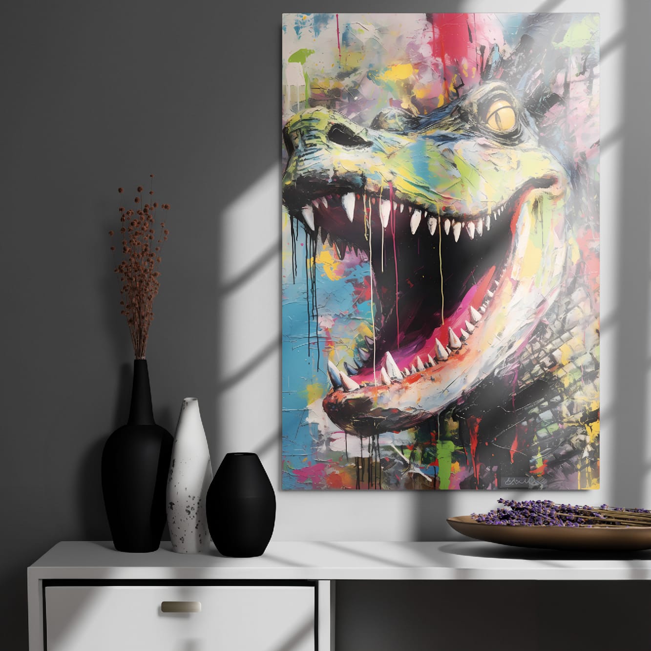 "Primal Roar" glossy metal poster 24"x36" on modern gray wall above console decor with window-light shadows, bold abstract dinosaur wall decor featuring open mouth, razor teeth, amber-yellow eye, teal face, and multicolor paint-drip graffiti background, by GiveMeMood
